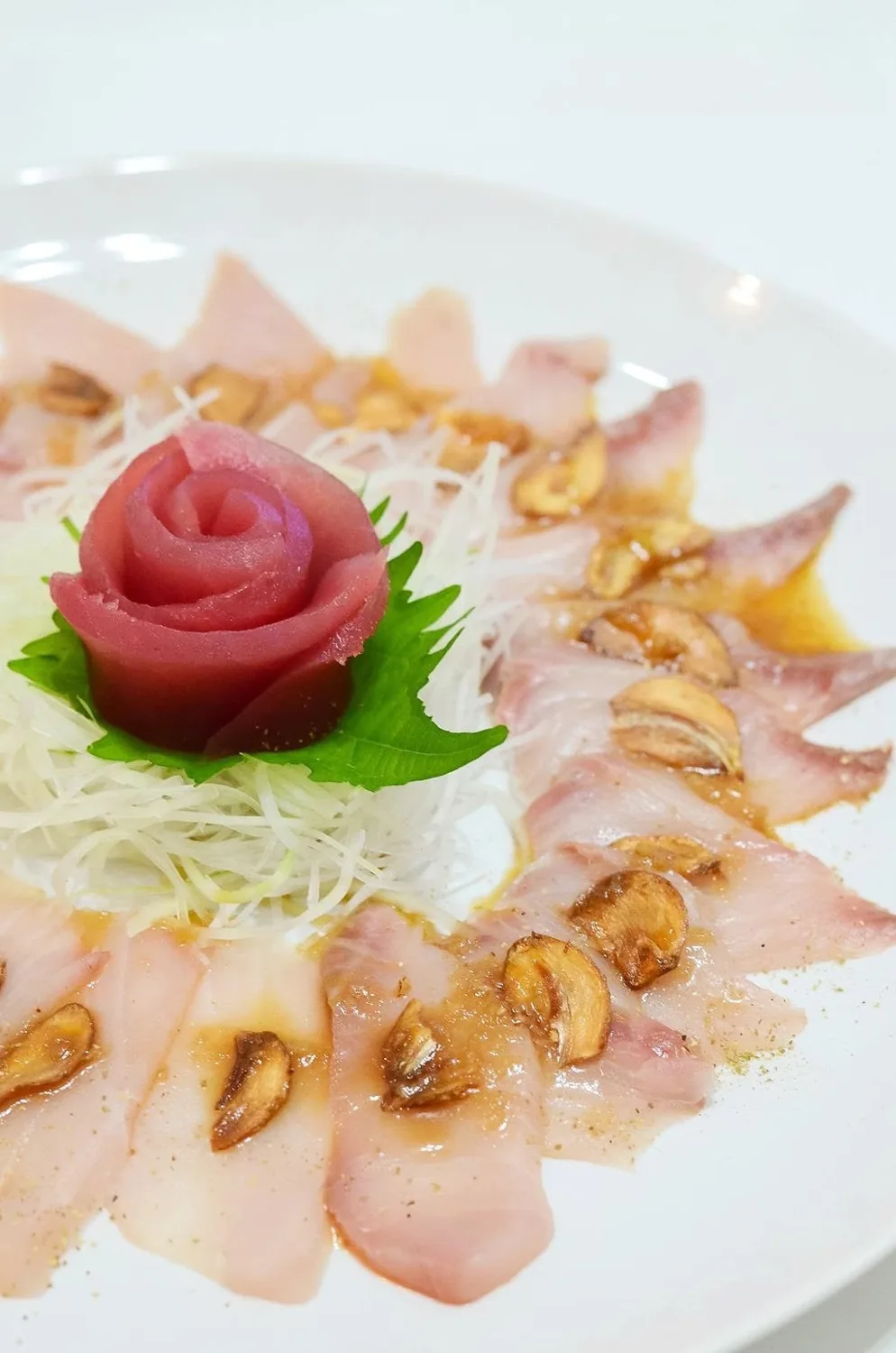 Hamachi carpaccio with a tuna rose and crisp garlic