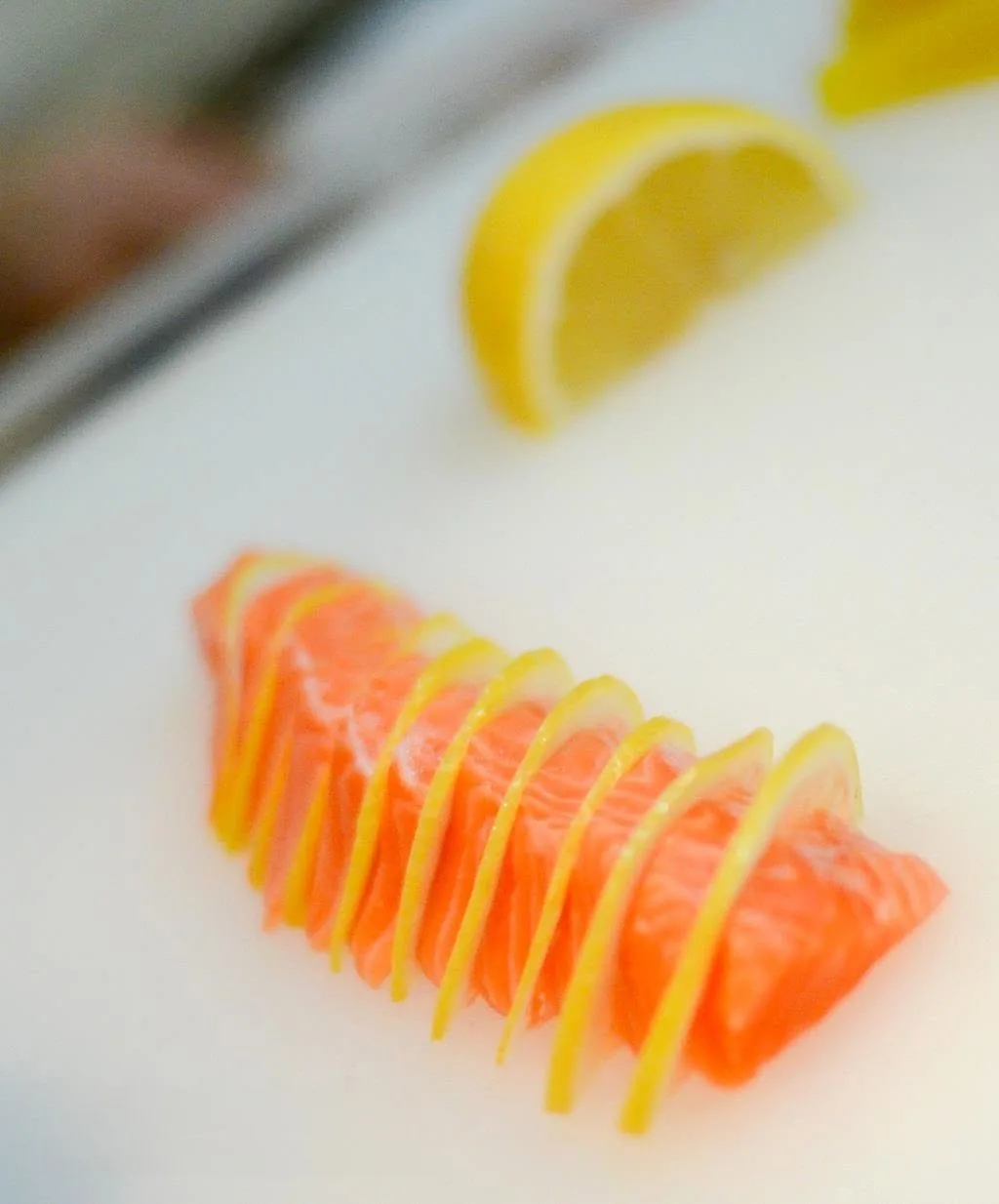Salmon slices layered with thin lemon