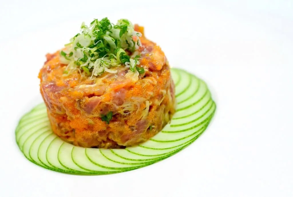 Salmon tartare tower on a ring of sliced cucumber