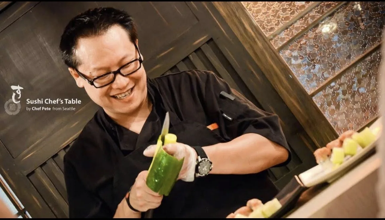 Chef Pete smiling while preparing ingredients for the chef's table